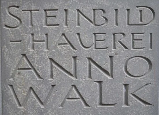 In Stein gehauener Schriftzug „Steinbildhauerei Anno Walk“